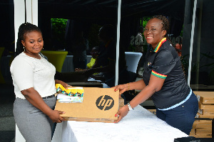 MTN Bright Scholarship Beneficiary Receiving A Laptop And Airtime From Cynthia Mills Of The MTN Ghan