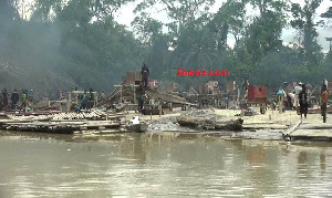 Illegal small scale miners busily prospecting for gold from the Pra River