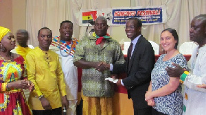 Dr. Isaac Odame (in suit) receiving the donation