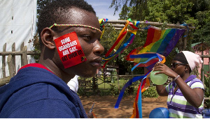 A Ugandan man with a sticker on his face takes part in the annual gay pride in Entebbe, Uganda