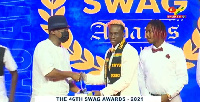 Boxer, Samuel Takyi picking up an award