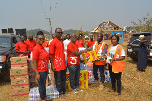 Mr. Eldon Otu (middle) presenting the items to the NADMO officials