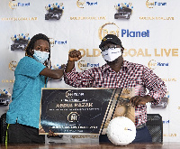 Mr. Sosthenes Galevo, Country Manager for Planet Sports Limited presenting the Golden Goal Ticket