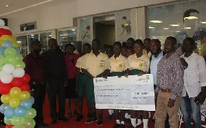 Christian Methodist students and officials show off the Cheque for Ghc3000