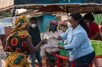 Naa Momo Lartey gifts a woman with some food stuff