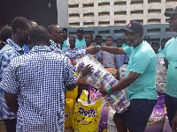 Board Chairman of Opportunity International, Katey Asem presenting the items to the school