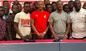 Andre Ayew and Kwesi Appiah flanked by other people