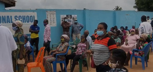 Scores of registrants gathered outside and awaiting their turn to go through the process