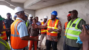 Minister of Youth and Sports interacting with some contractors when he paid a visit to the facility