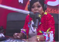 Afia Schwarzenegger seated behind a radio console inside Angel FM studio