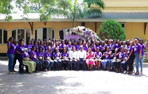 Female staff of Olam poses Amit Agrawal, and Kenneth Antwi after a workshop.