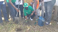 Etornam James Flolu planting a tree