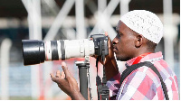 A photo journalist covering  an event