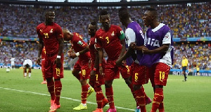 Asamoah Gyan of Ghana celebrates with his teammates scoring