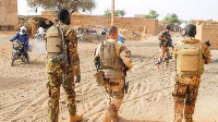 Soldiers of the Barkhane Force and the Malian army patrol in a street of Menaka, Mali