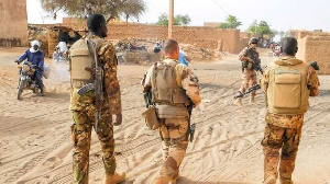 Soldiers of the Barkhane Force and the Malian army patrol in a street of Menaka, Mali