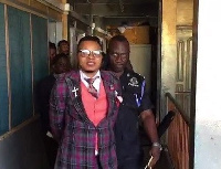 A photo of Obinim in police grips