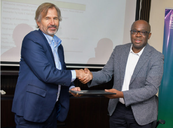 Kyle F. Kelhofer (left) and Kwamina Asomaning (right) after the signing