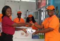 Lois Beryl Nortey, president of GPOG R) presenting the items to Korkor Badger