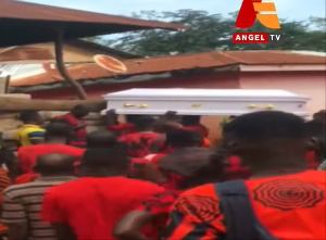 Pallbearers carrying the coffin to the cemetery