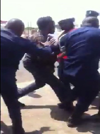 Police officers beating the taxi driver