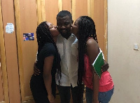 Actor John Dumelo sandwiched between two ladies