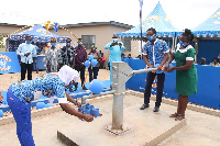 Mr. Harrison Nyarko and Nurse Diana Akwaiba pump water from the borehole