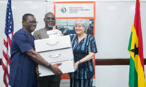 US Ambassador, Stephanie Sullivan donating technology to EOCO boss, Frank Adu-Poku & Jacob Puplampu