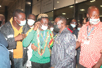 Ben Nunoo Mensah (r), Ghana Olympic Committee President, conferring with Samuel Takyi at the airport