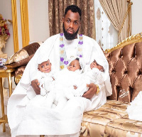 Reverend Francis Antwi captured with his triplets