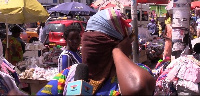 A Makola market trader ties her whole face with a handkerchief due to the fear of coronaviirus