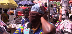 A Makola market trader ties her whole face with a handkerchief due to the fear of coronaviirus