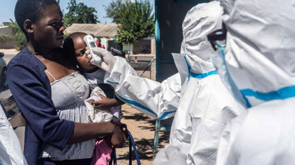 Medical personnel check temperatures of patients visiting on April 25, 2020, Mpilo Hospital in Bulaw