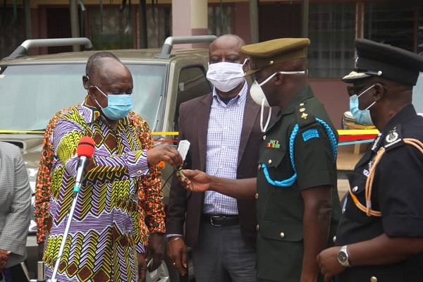 Ashanti Regional Minister, Simon Osei Mensah handing over keys to the vehicles to GAF