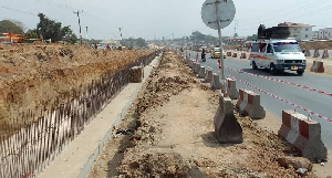 The project includes an 8-lane road with 2-lane service roads on each side