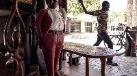 A worker in the streets of the artisanal and traditional fishers village of Soumbedioune in Dakar