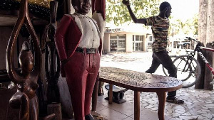 A worker in the streets of the artisanal and traditional fishers village of Soumbedioune in Dakar