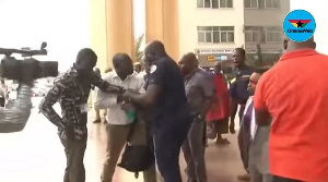 The Police officer in a scuffle with David Andoh over the latter's camera