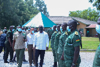 Lands Minister observing a guard of honour at the premises