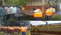 The DCE presenting the roofing sheets to the acting Headmaster of the school