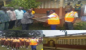 The DCE presenting the roofing sheets to the acting Headmaster of the school