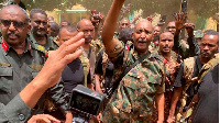 Army chief Abdel Fattah al-Burhan (C) cheering with soldiers