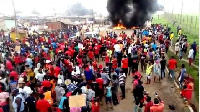 The protestors wearing red bands with placards, blocked the main road, set ablaze car tyres