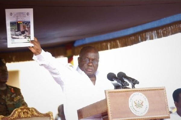 President Akufo-Addo with a copy of the Ghana Beyond Aid book