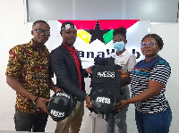 Latif Iddrisu (in coat) presenting the equipment to staff of GhanaWeb