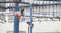 Workers remove the billboard of Owusu Aduomi, an Ashanti Regional chair aspirant