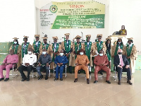 Some graduates with authorities of the school in a group photograph