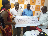 GHALCA chairman, Kudjoe Fianoo (far right) receiving the dummy cheque from a StarTimes official