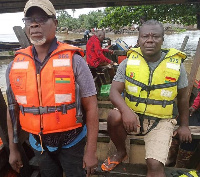 Some members of the Nzema East Municipal Assembly helping with the evacuation of  trapped residents