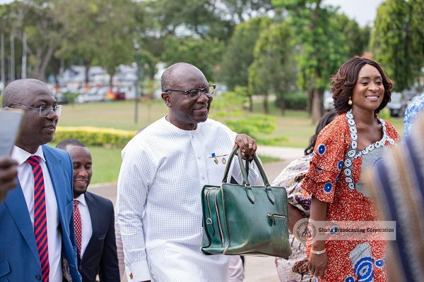 Ken Ofori-Atta (with green bag)